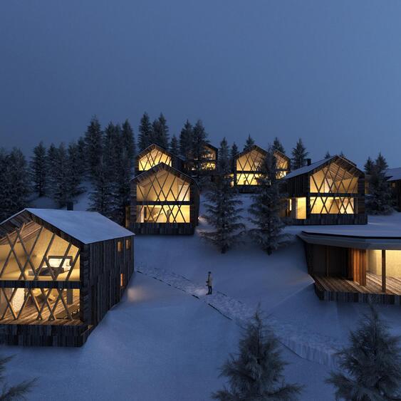 Beleuchtete Amus Chalets in verschneiter Winterlandschaft in der Abenddämmerung.