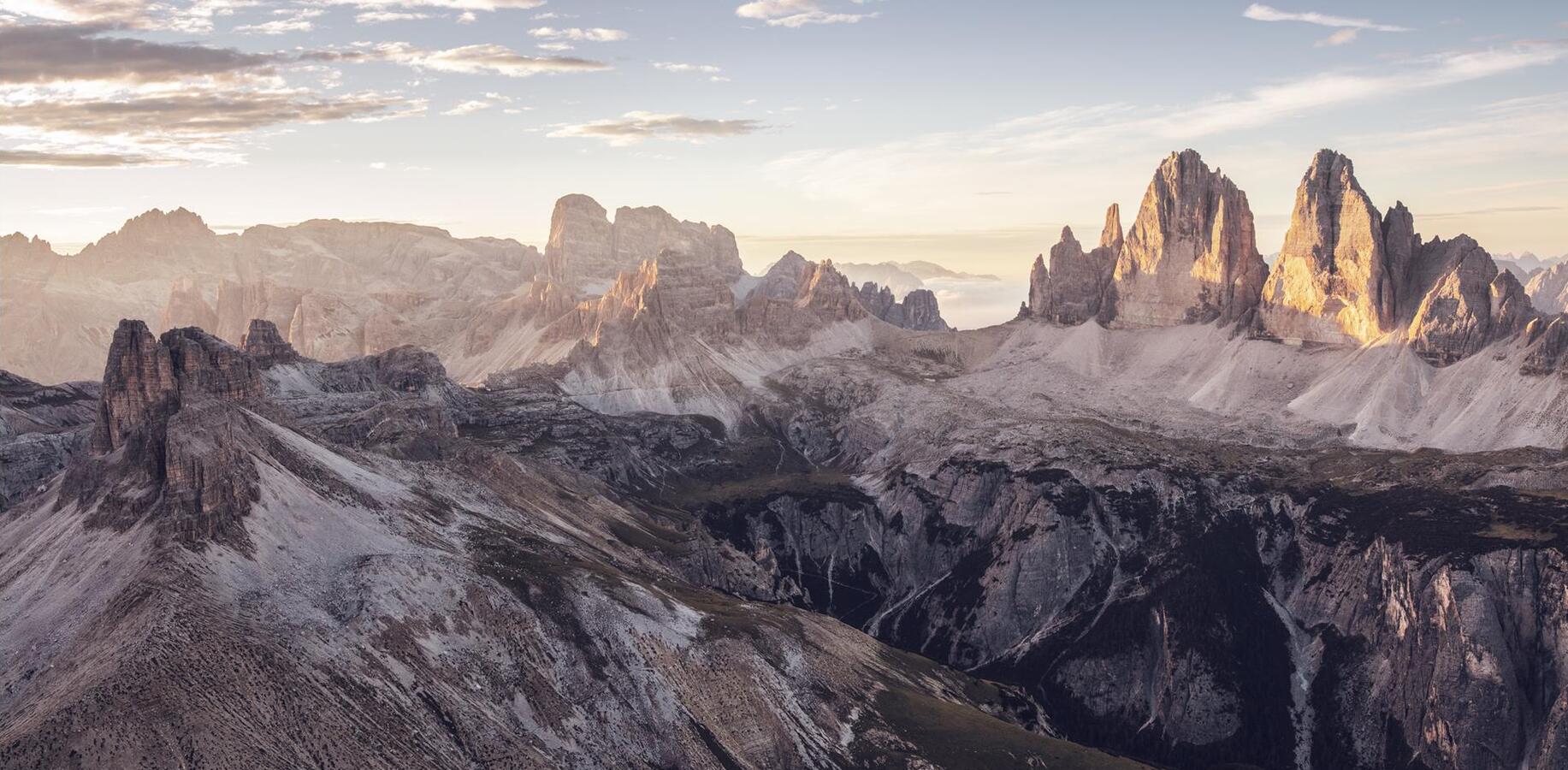View of the Three Peaks at sunrise, surrounded by the distinctive Dolomite landscape.